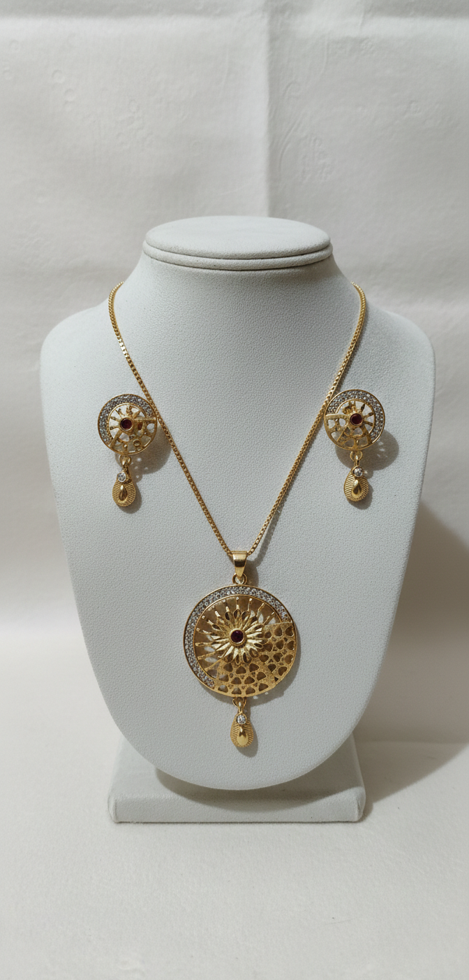 Gold necklace and earrings set on a white mannequin bust against a white background