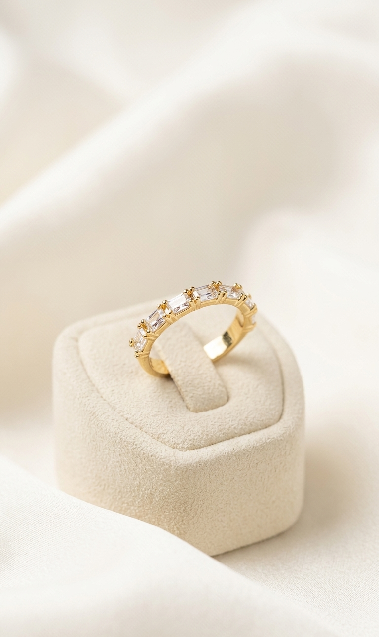 Gold ring with diamonds on a white cushion