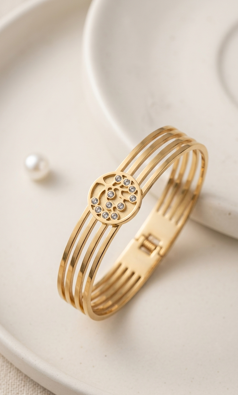 Gold bracelet with a heart design on a white plate
