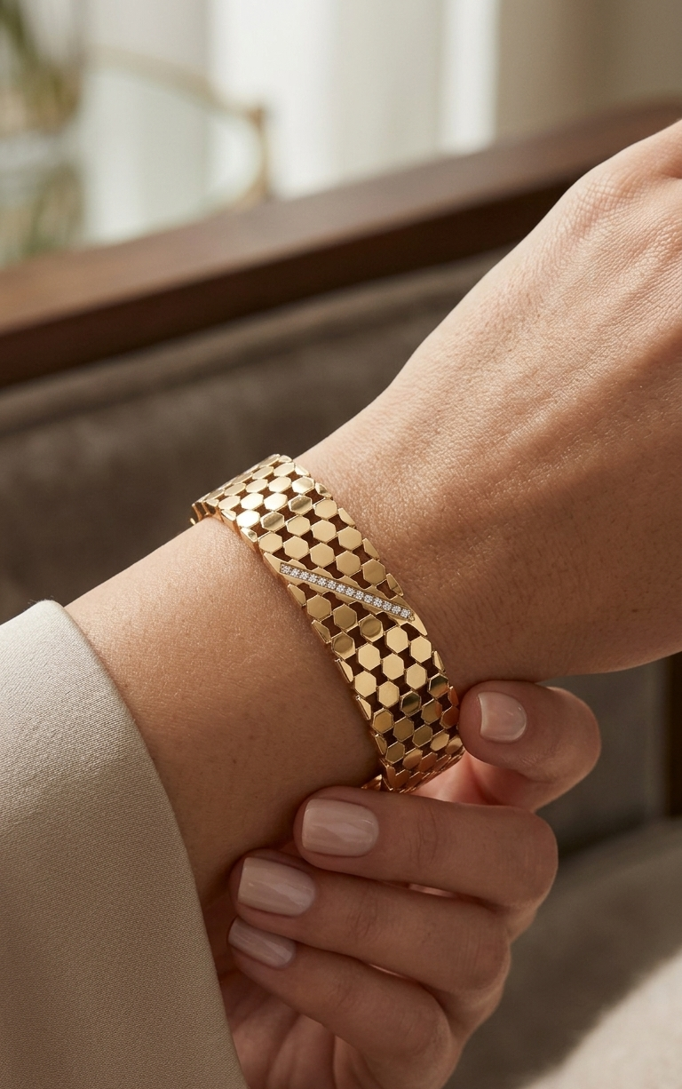 Gold bracelet on a wrist with a blurred background