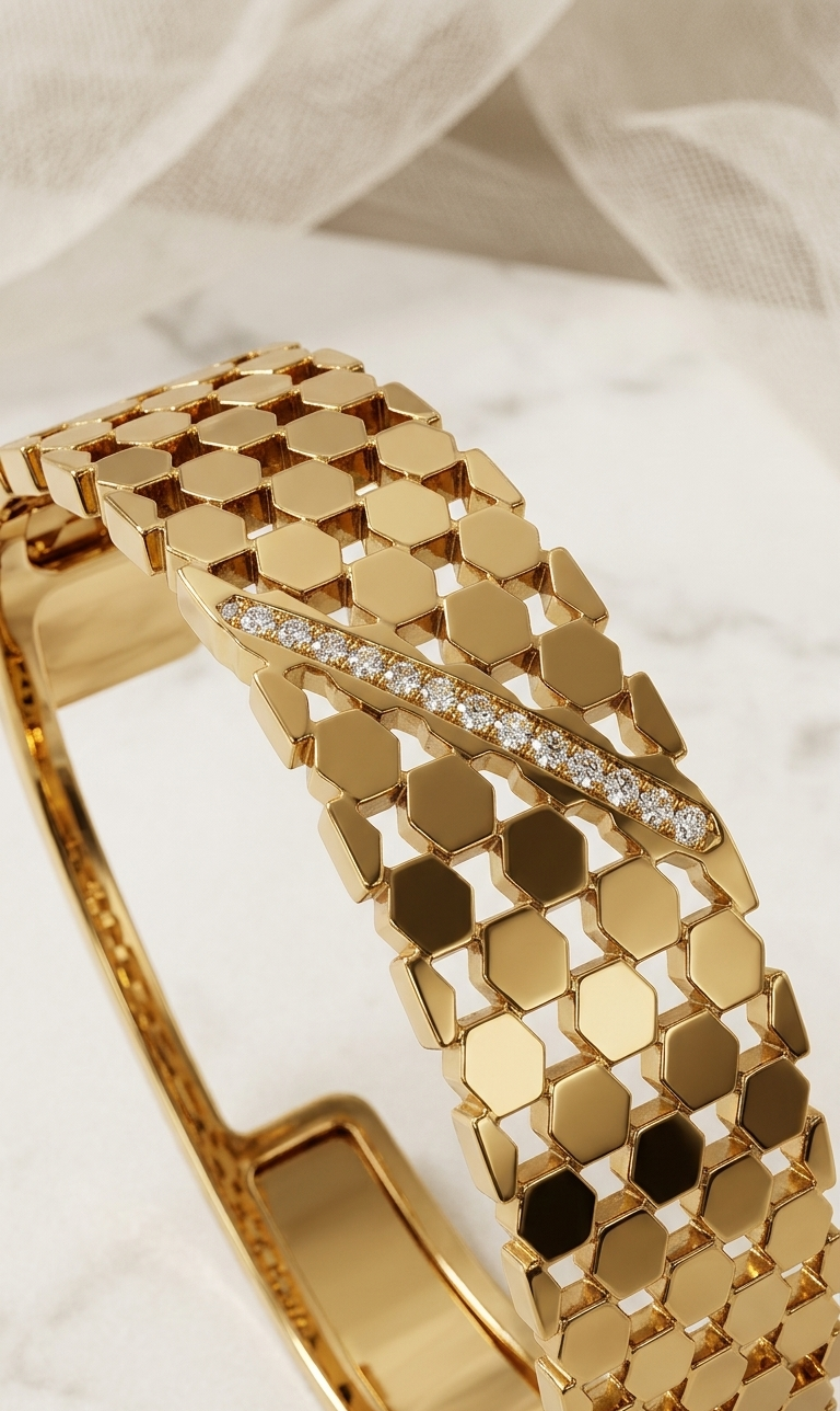 Gold bracelet with hexagonal pattern and diamond accents on a light background