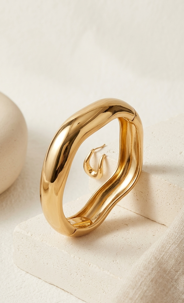 Gold ring on a textured beige surface