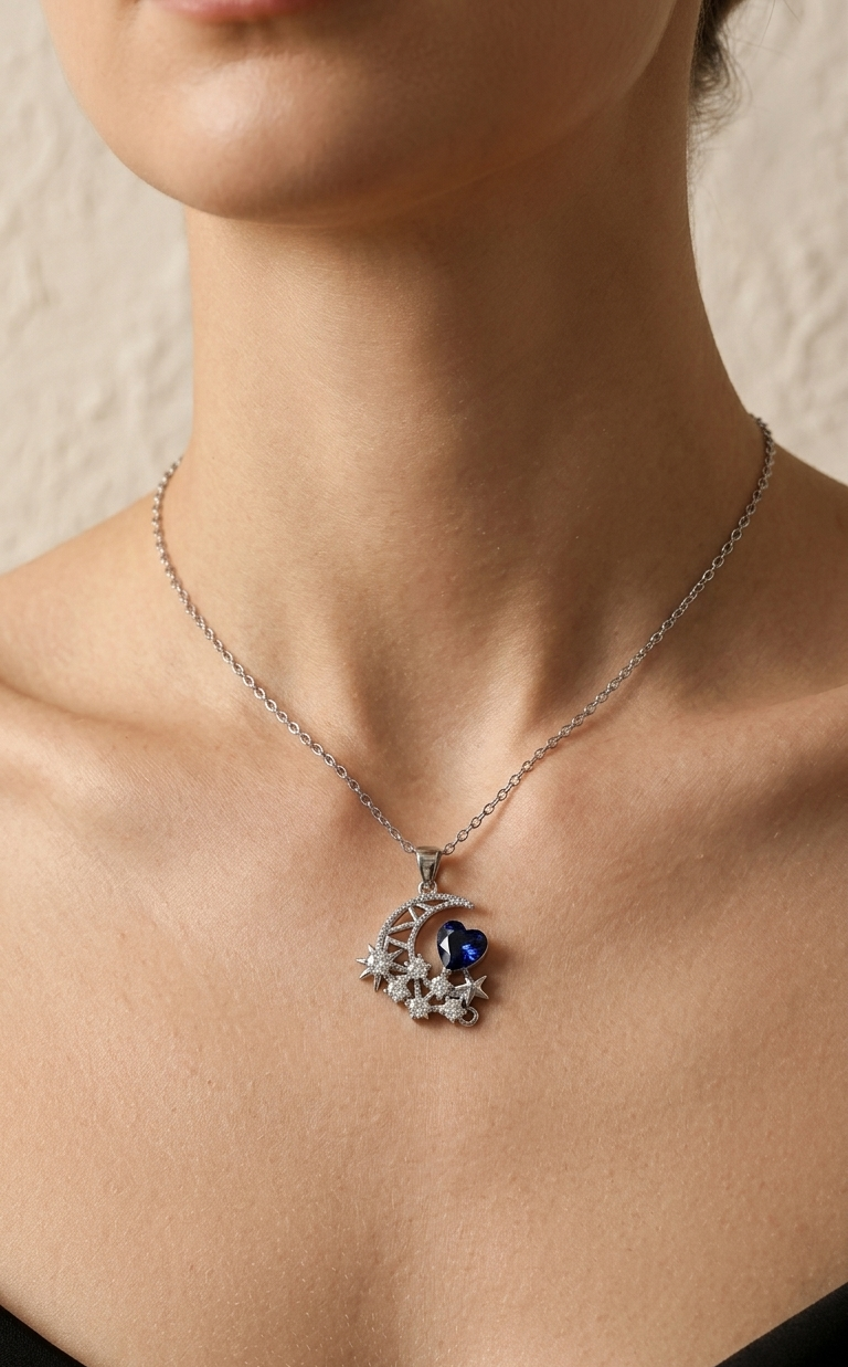 Necklace with a pendant featuring a blue gemstone on a person's neck against a neutral background