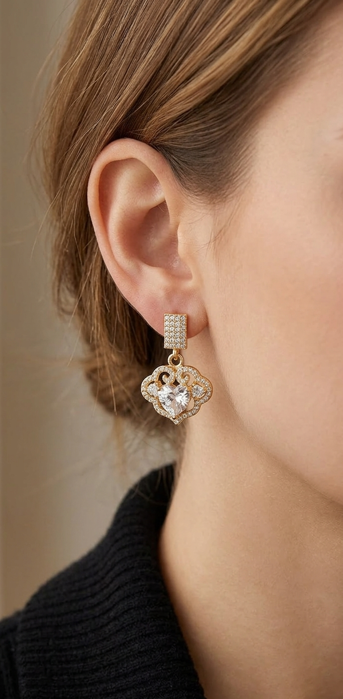 Close-up of a person wearing a diamond earring with a neutral background