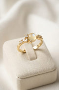 Gold ring with a pearl on a soft white background