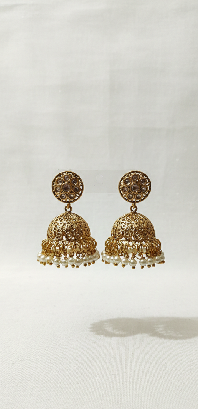 Pair of gold earrings with intricate designs on a white background
