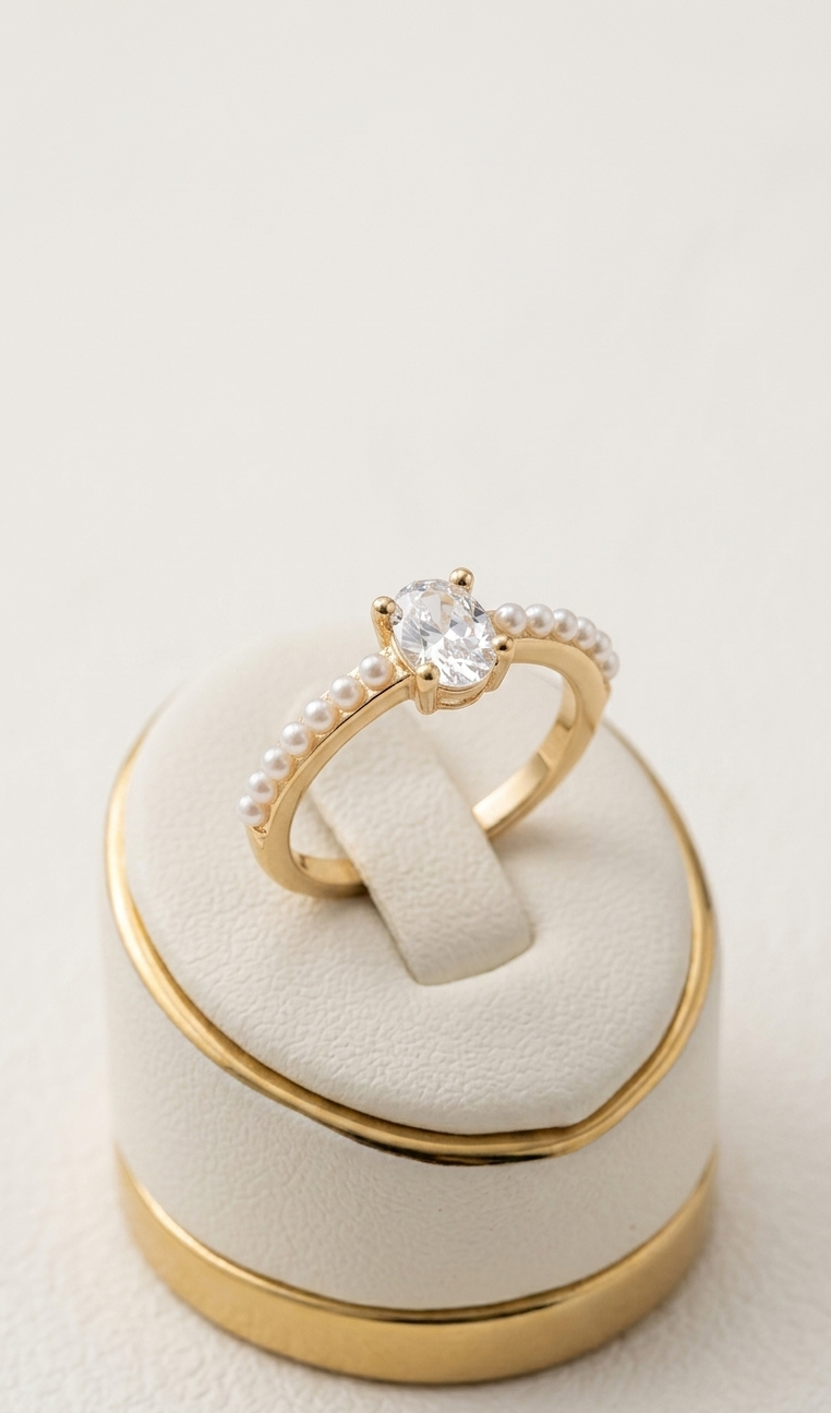 Gold ring with a diamond on a matching gold and beige ring box
