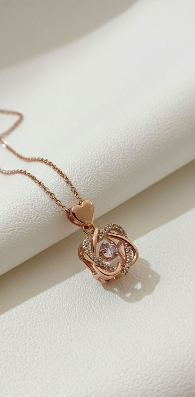 Rose gold necklace with a heart-shaped pendant on a light beige background